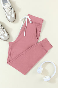 Fuchsiafarbene Jogginghose mit Kordelzug an der Taille und Taschen